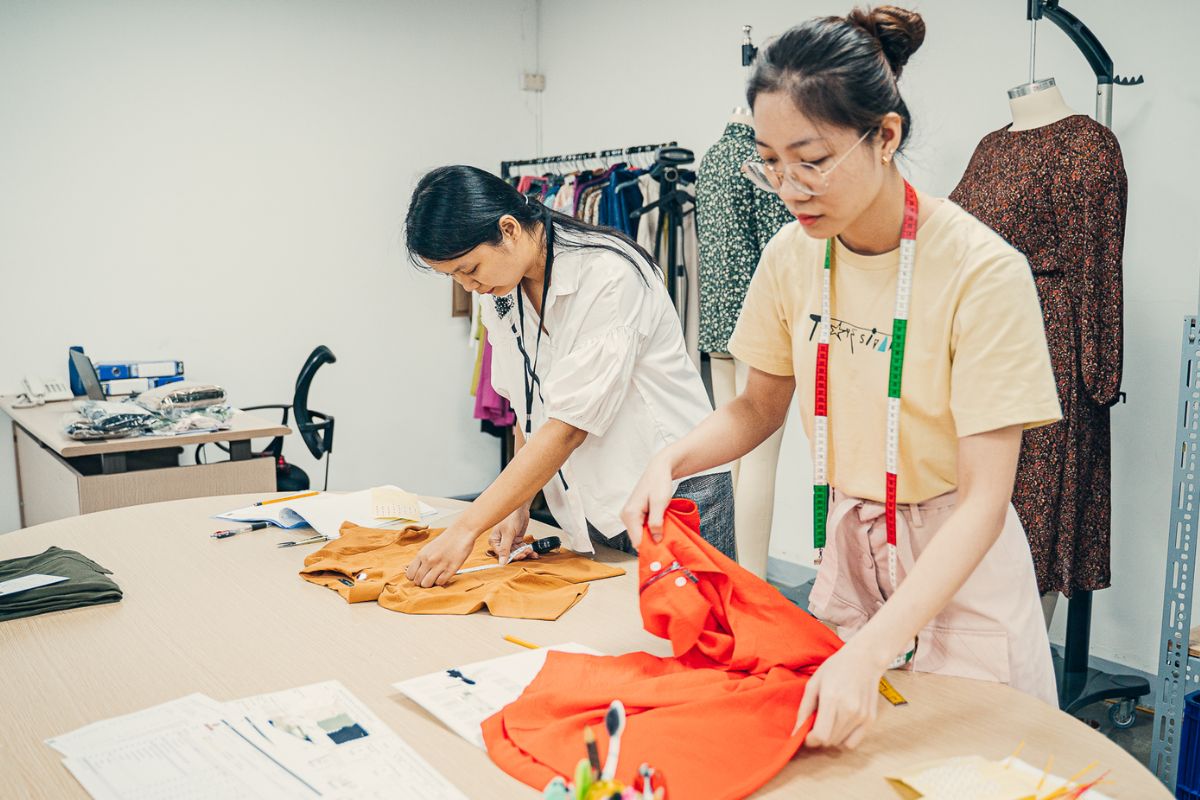 professional designers making clothes from materials in kiara garments factory
