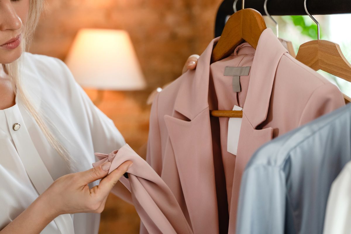 woman checking quality of finished clothes
